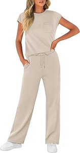 Detail of loose fit short sleeve top with pocket and wide leg pants in beige