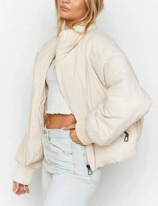 Detail view of cream oversized puffer jacket with quilted diamond pattern and high collar