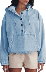 Detail of light blue denim hoodie featuring half-button placket and front kangaroo pocket