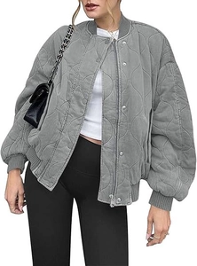 Detail of grey quilted bomber jacket featuring wave stitching and ribbed knit trim