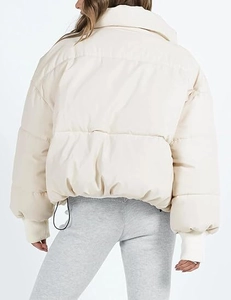 Back view of cream puffer jacket featuring high collar and ribbed cuffs for women