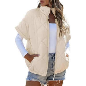 Women's beige quilted puffer vest with standing collar, zipper pockets, and diamond pattern