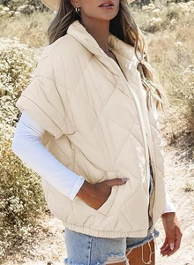 Detail of beige diamond-quilted puffer vest featuring a stand collar and side pockets