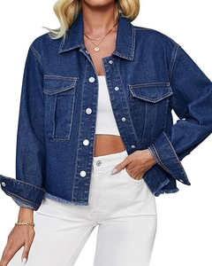Close-up of women's denim jacket showing raw hem detail and dual chest pockets