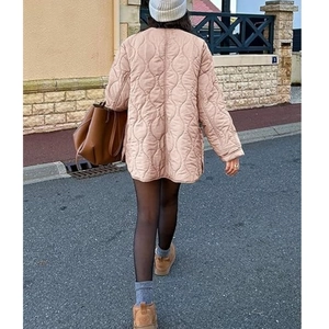 Rear view of a dusty pink quilted jacket featuring unique wavy stitching for casual winter style