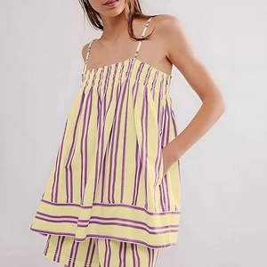 Detail of summer two-piece set featuring striped yellow fabric and smocked bodice texture