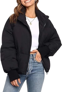 Close-up of black puffer jacket showing ribbed cuffs and windproof stand collar