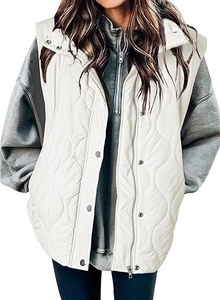 Detail of white wavy quilted vest featuring silver snap buttons and zipper closure