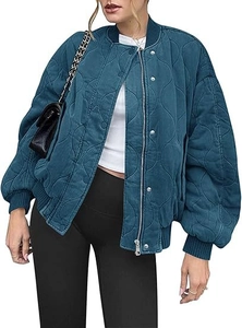 Detail view of wave-quilted pilot jacket with ribbed collar and metal zipper closure