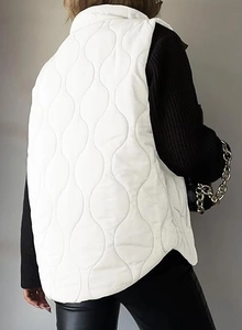 Rear view of white quilted vest with wave pattern quilting and a minimalist stand collar