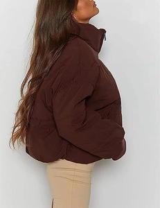 Detail view of the elastic cuff and quilted texture on a chocolate brown puffer jacket