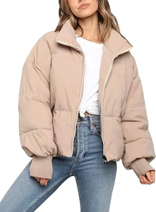 Detail of windproof ribbed cuffs and silver metal zipper on beige puffer jacket