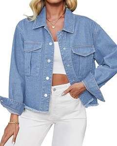 Detail of light blue denim jacket featuring raw hem fringe and metallic button fasteners