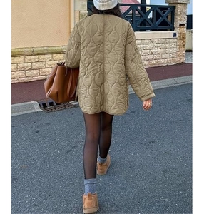 Close-up of olive green onion-quilted jacket featuring a relaxed fit and long sleeves