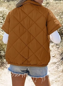 Detail of caramel diamond quilted jacket featuring a stand collar and elastic hemline