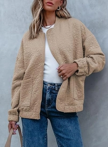 Detail of khaki quilted bomber jacket with intricate floral embossing and front zipper
