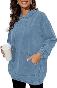 Close-up of acid-washed blue denim hoodie featuring drop shoulders and large front pocket