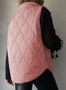 Pink quilted vest with wavy stitching, stand collar and high-low hem side view