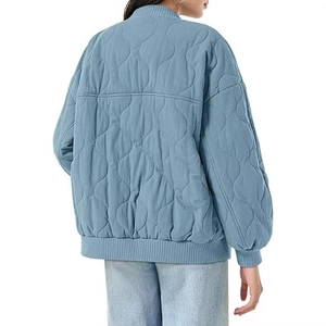 Women's oversized blue quilted bomber jacket with classic ribbed trim and long sleeves