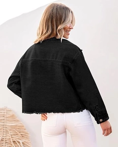 Rear view of cropped black washed denim jacket with frayed hem and metal button details