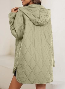 Detail view of women quilted hooded jacket with diamond pattern and side slit