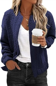 Detail of dark blue jacket featuring embossed 3D floral texture and zipper closure