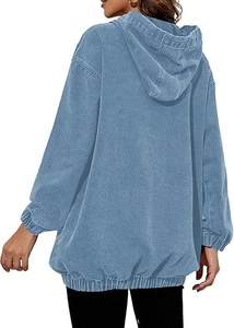 Rear view of light blue oversized hoodie showing vintage washed denim texture and ribbed hem