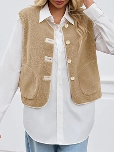 Detail view of khaki sherpa vest with round neck and buttons over a white long sleeve shirt