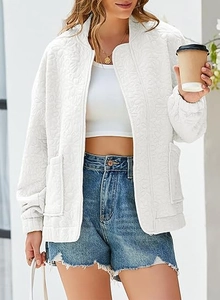 Detailed view of white long sleeve jacket featuring floral embossed texture and zipper