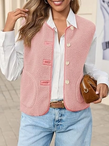 Detail of pink faux shearling vest with white buttons and large side pockets