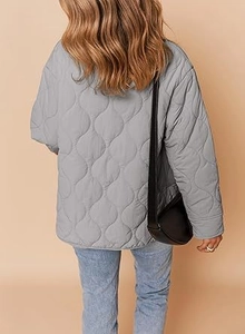 Detail view of light grey quilted jacket featuring onion-pattern stitching on the back
