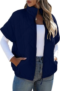 Detail of navy blue quilted vest showing diamond pattern and functional pockets