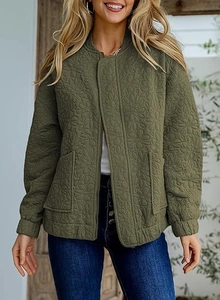 Detail of olive green quilted bomber jacket featuring unique 3D floral texture and pockets