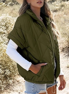 Detail of olive green quilted vest featuring a high collar, zipper, and elastic hem