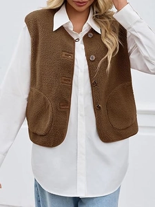Detail of brown faux shearling vest featuring texture and round wood-style buttons