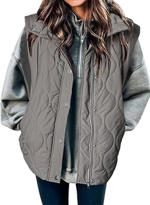 Detail of grey quilted vest featuring onion pattern stitching and metal zipper closure
