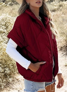 Macro detail of wine red quilted vest texture with standing collar and zipper closure