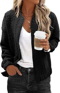 Close-up of black quilted jacket with 3D floral texture and metal zip front