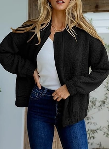 Detail of black quilted jacket featuring 3D floral texture and stand-up collar design