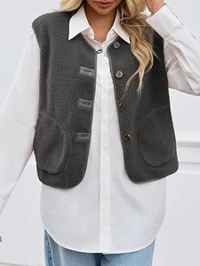 Close-up of dark grey sherpa fleece vest with wooden buttons and front patch pockets