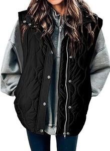 Detail of black quilted vest with silver snap buttons and zipper over a grey hoodie