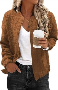 Detail of caramel brown floral embossed jacket with a metal zipper and relaxed fit design