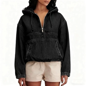 Detailed macro view of black washed denim fabric with hood drawstring and metal zipper