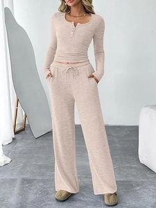 Detail of oatmeal ribbed knit two-piece set featuring henley neck and wide-leg drawstring pants