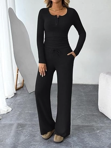 Detail of black ribbed long-sleeve two-piece set featuring henley neck and drawstring waist