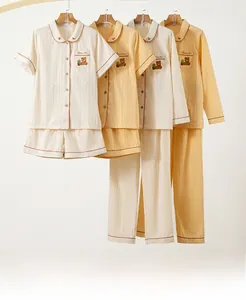 Detail of cotton pajama set with bear embroidery and vertical stripe texture