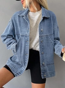 Detail of loose fit blue wash denim jacket for women featuring button closure and pockets