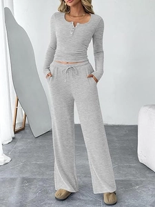 Detail of grey loungewear set featuring a buttoned Henley top and drawstring wide-leg pants