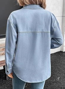 Back view of light blue washed denim shirt featuring back yoke and curved hemline