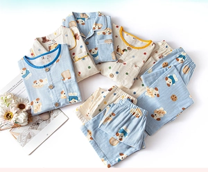 Detail view of cotton kids pajamas featuring cute cartoon puppy and toast prints on sets